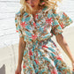 Get Whimsical Tropical Print Smocked Waist Neck Button Romper