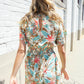 Get Whimsical Tropical Print Smocked Waist Neck Button Romper